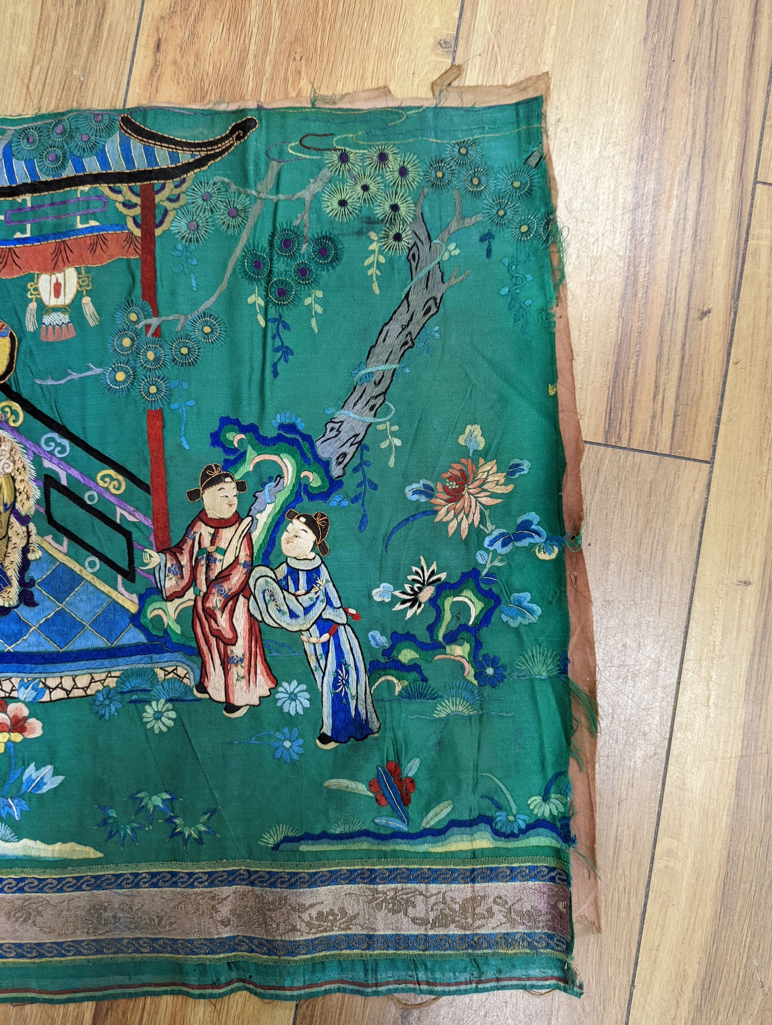 An early 20th century Chinese silk figurative embroidery from a larger panel of an emperor and empress scene.